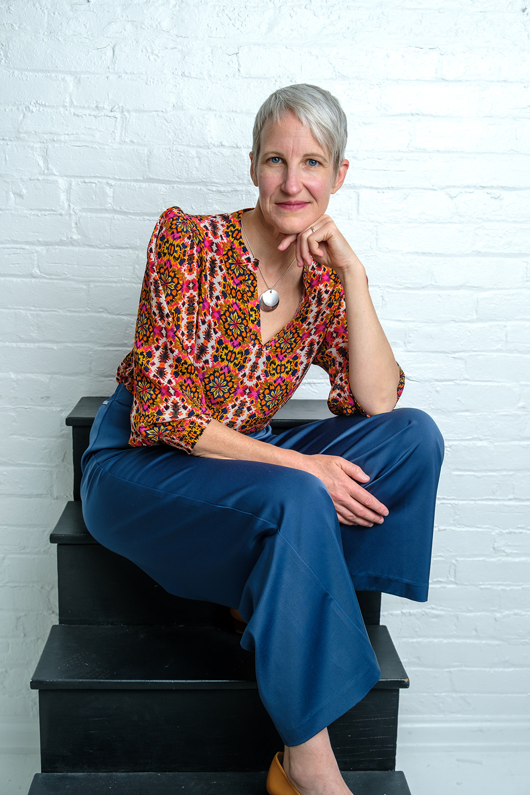 Kristen Peairs smiling in a patterned blouse